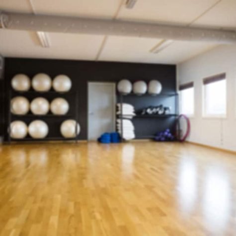 A gym room with a lot of balls on the floor for BLS training.